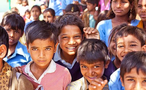 Sabbalpura, India - March 15, 2014: Group of happy indian school children posing in the rural village, Rajasthan, India.